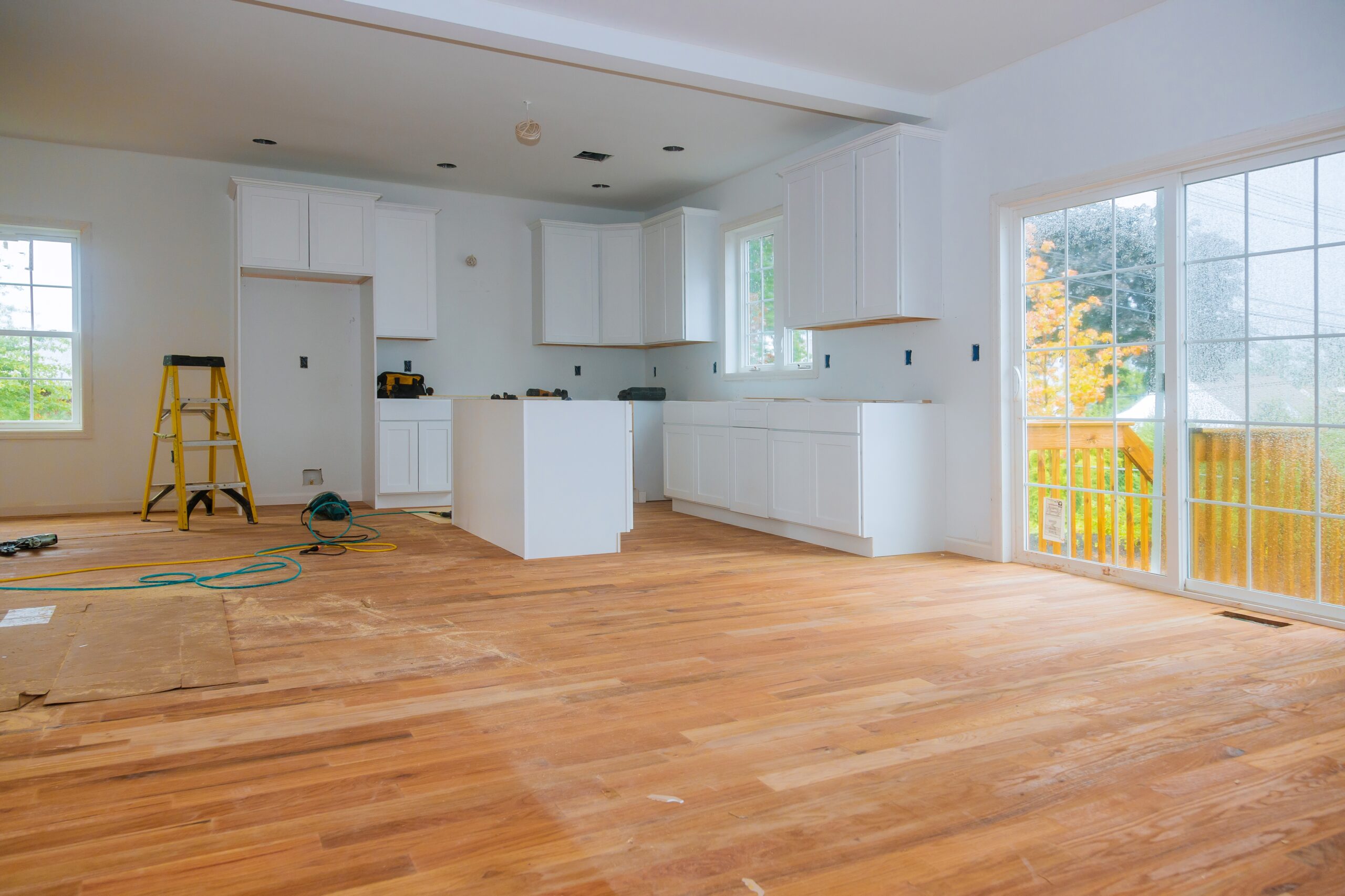 Newly remodeled kitchen with white cabinets and island, home improvement project in progress.