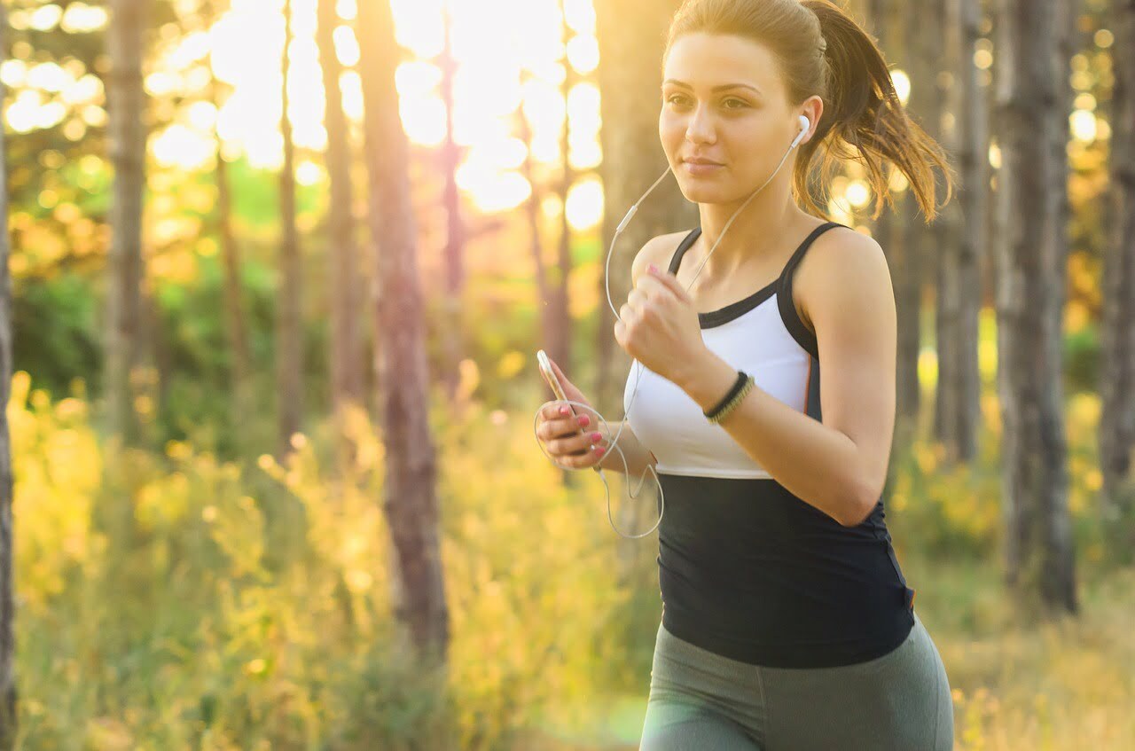 a woman running through a forest