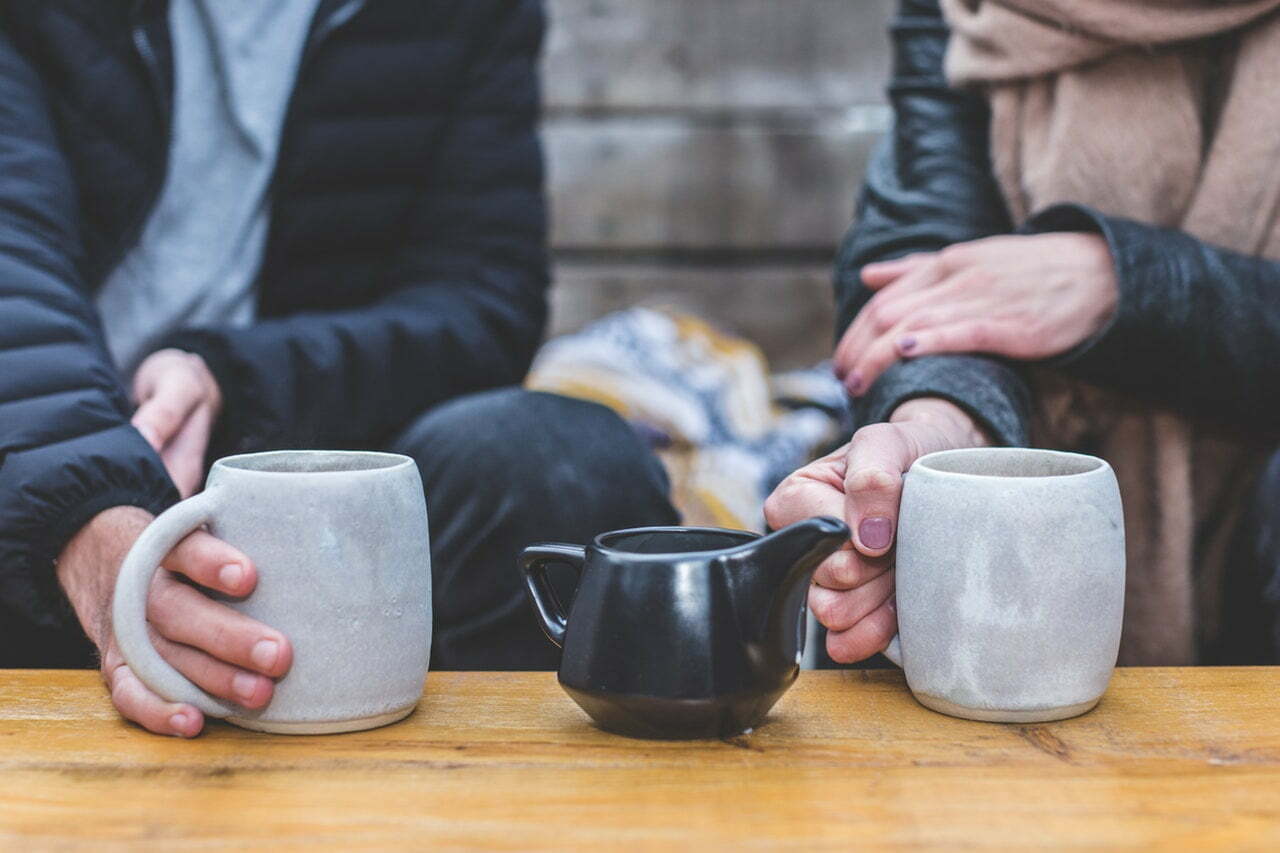 a group of people holding a tea cup