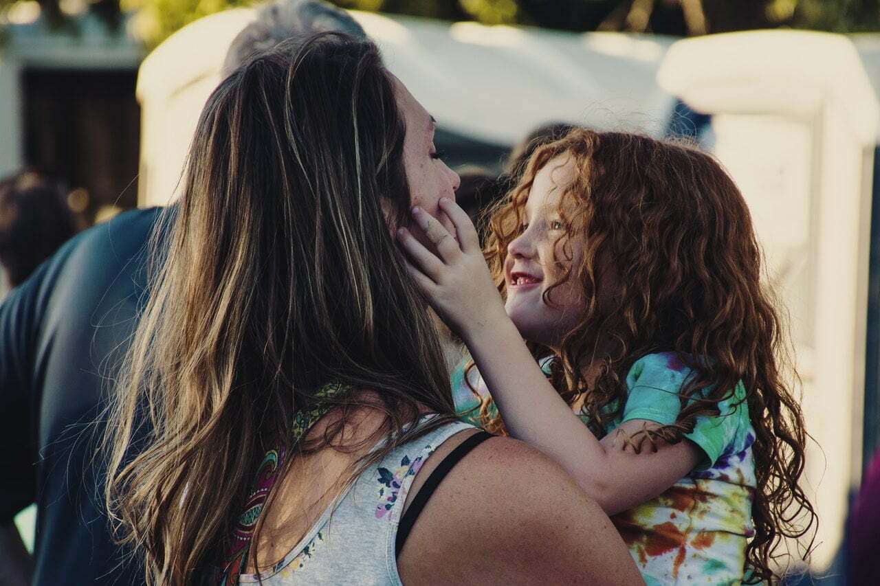 a woman holding a little girl