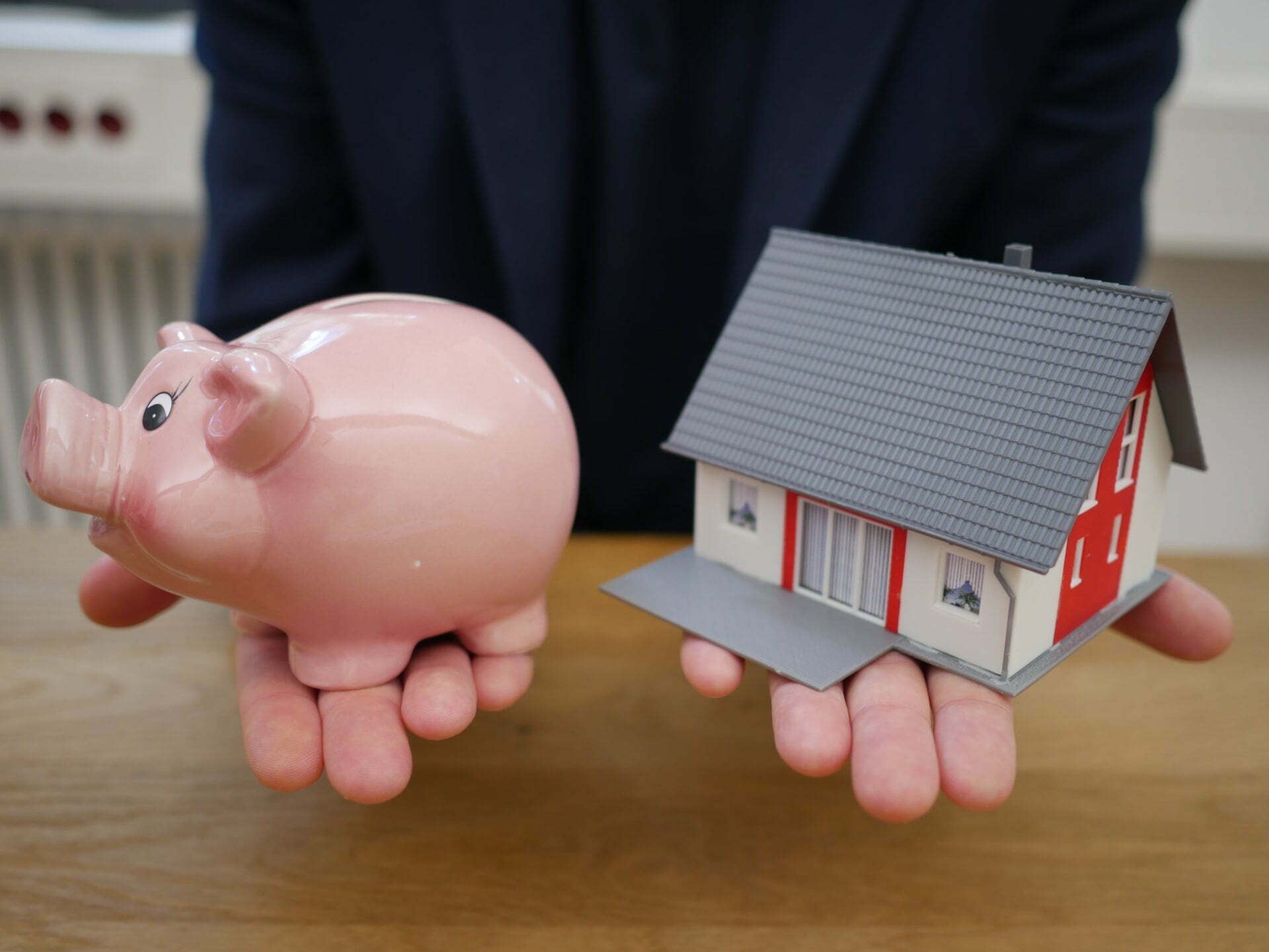 a pink piggy bank with a stack of money in it