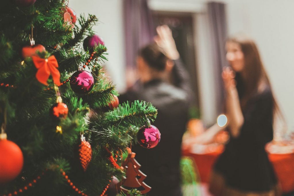 a christmas tree with a man and woman in the background