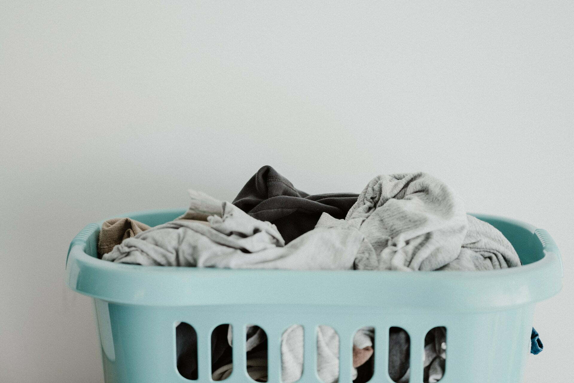 a blue bin full of clothes