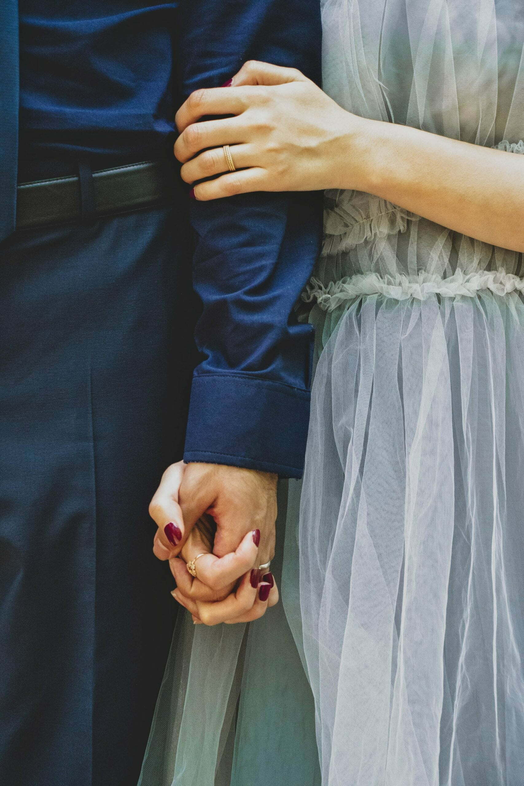 a person's hand holding a white cloth over a blue surface