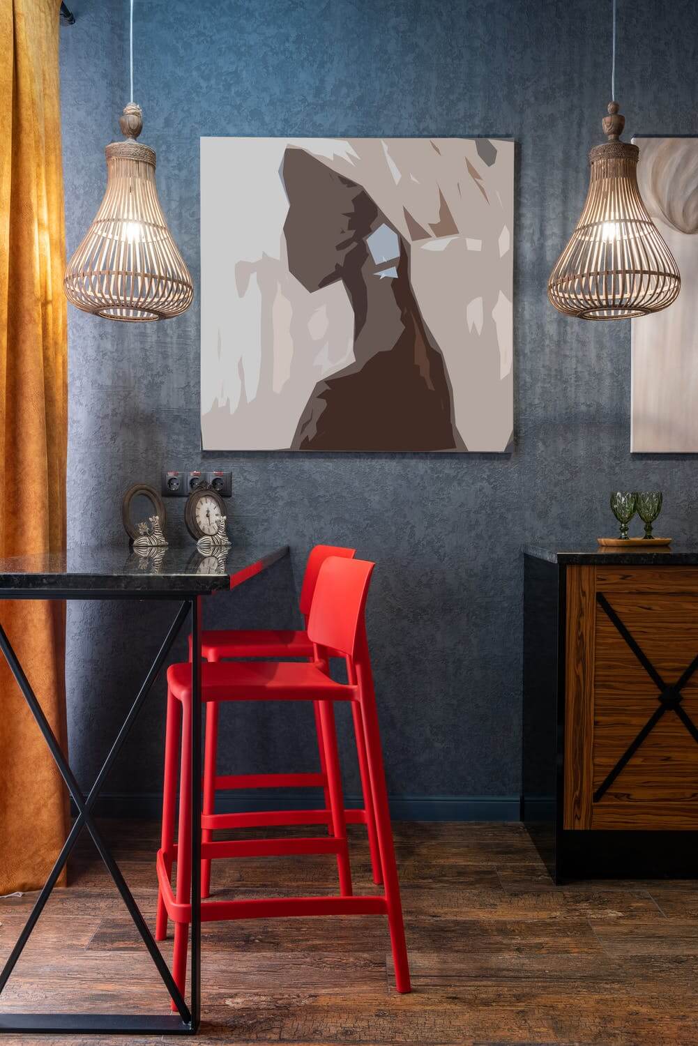 a red chair next to a painting