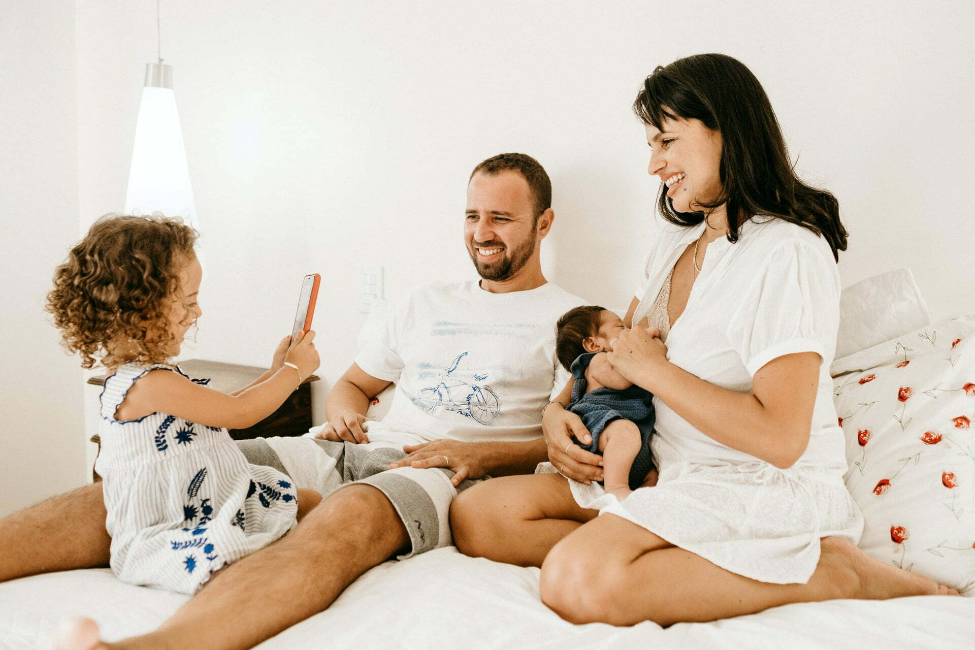 a family sitting on a bed