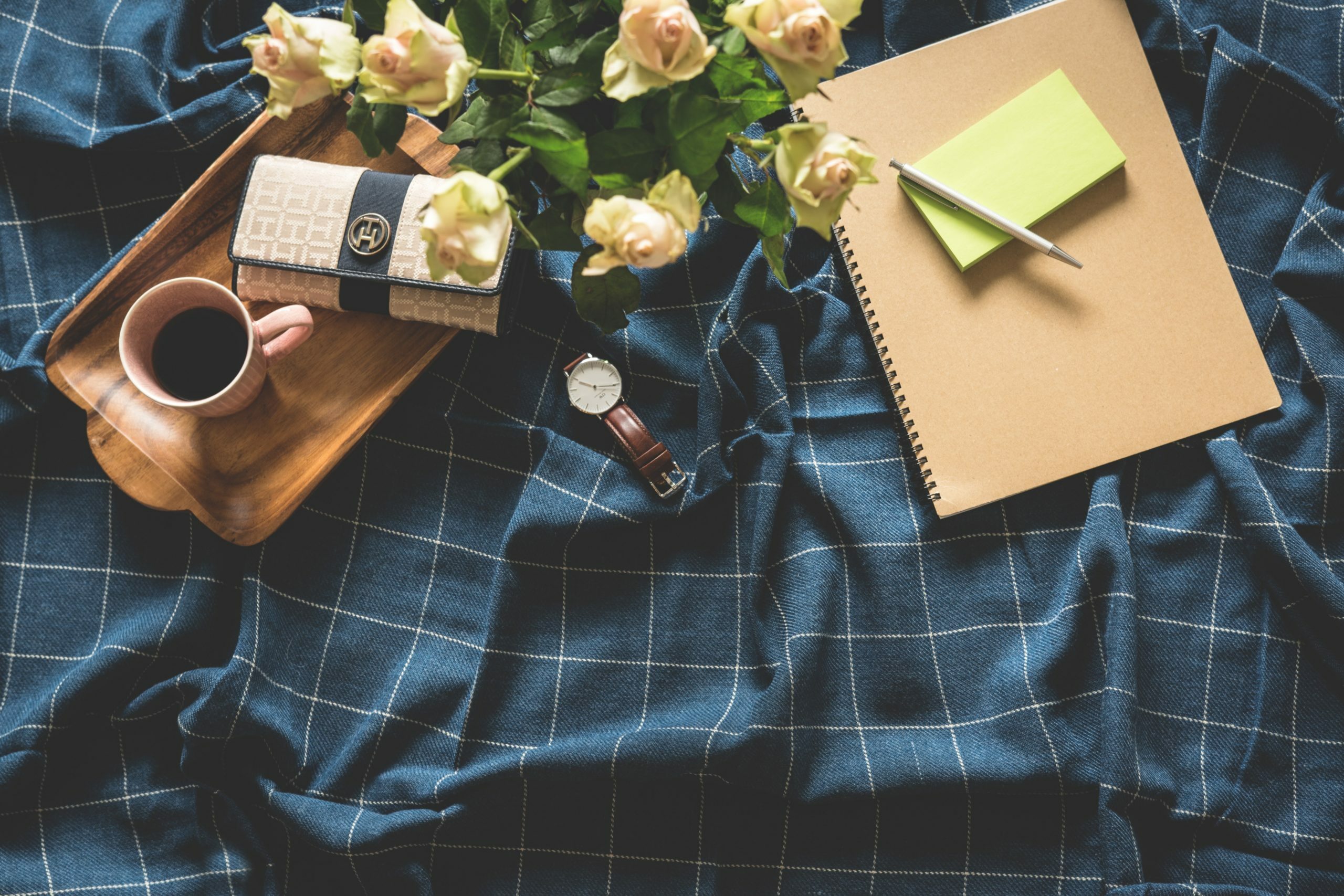 a person holding a book and a cup of coffee