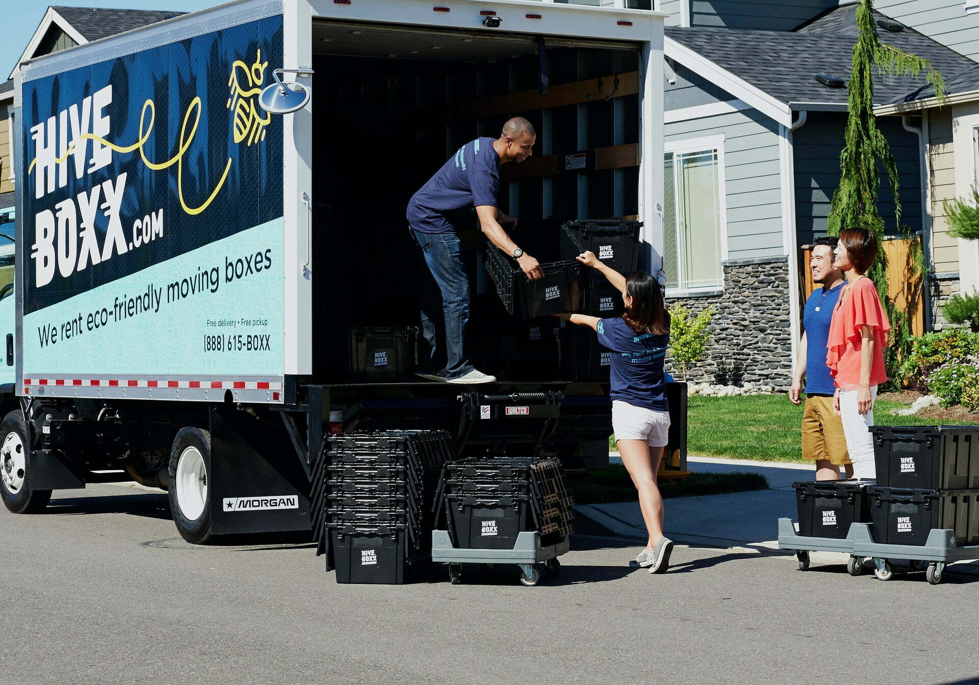 a man standing on the back of a truck with a ladder