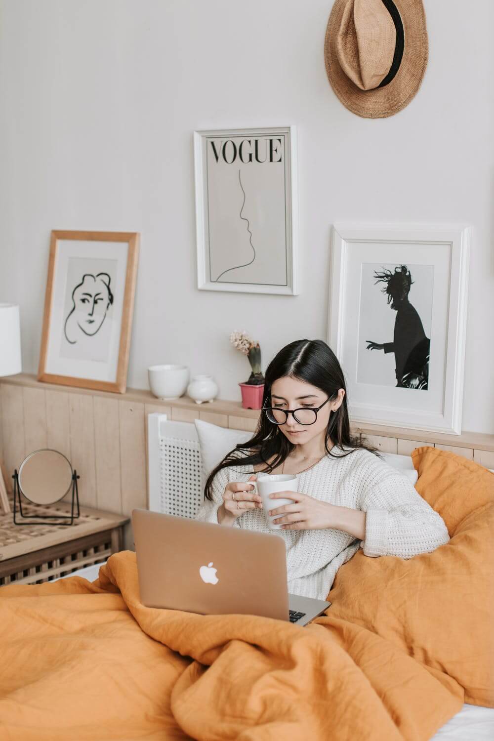 a person sitting on a couch with a laptop