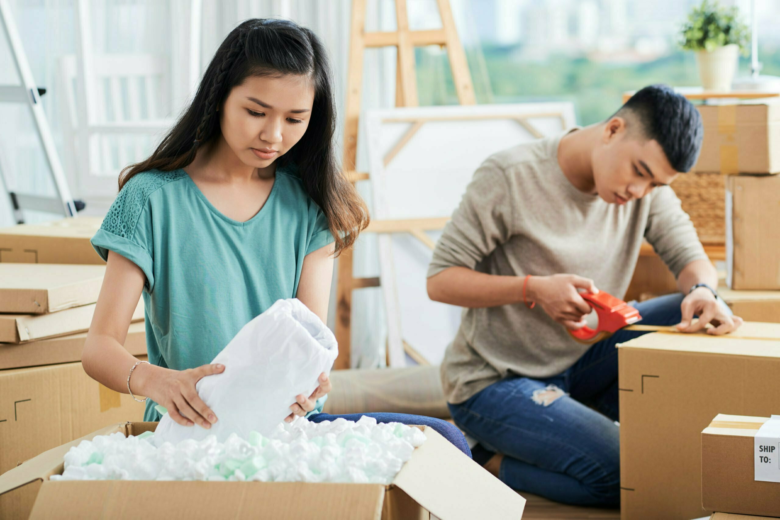 a man and a woman looking at a piece of paper