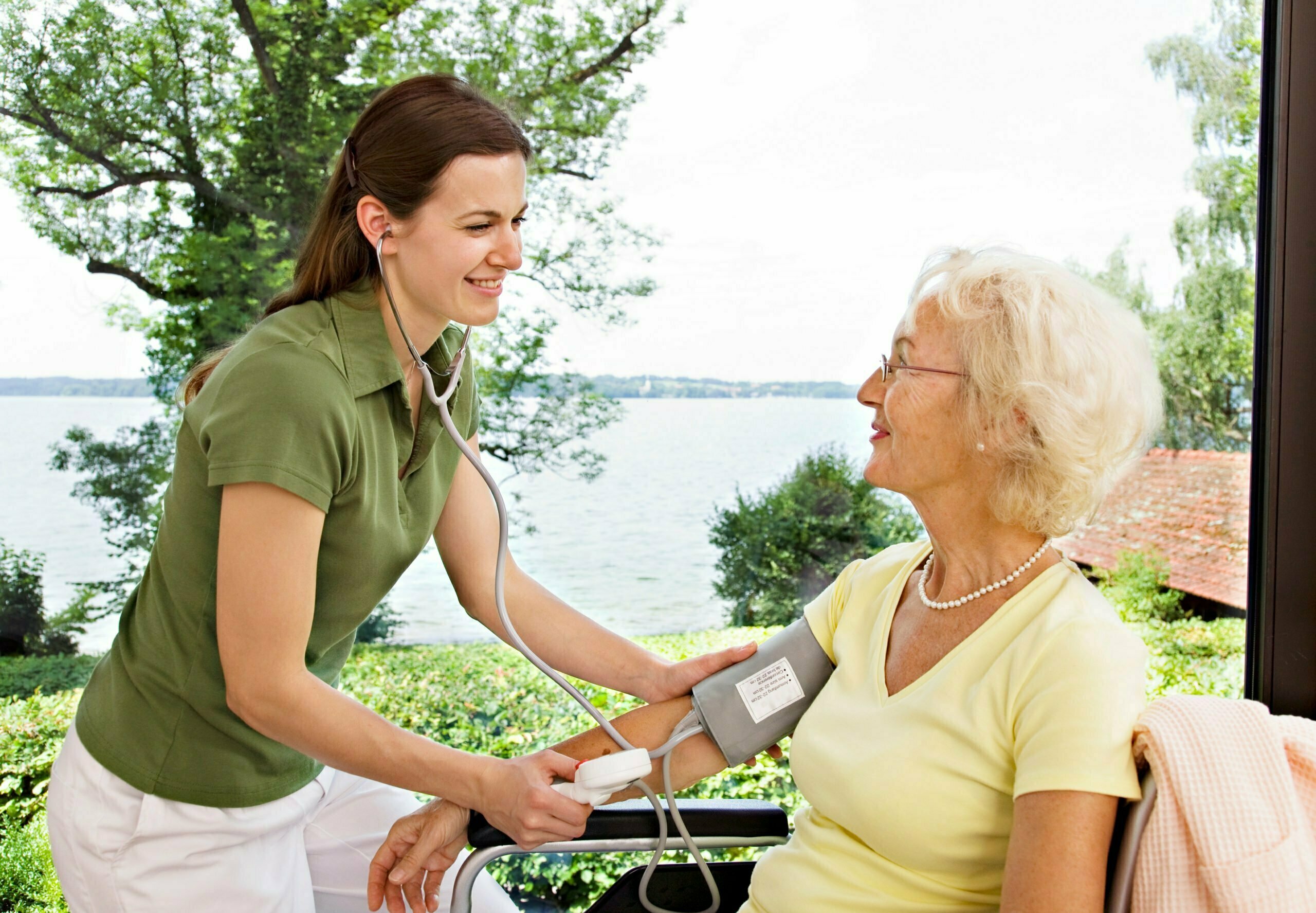 nurse taking woman's blood pressure