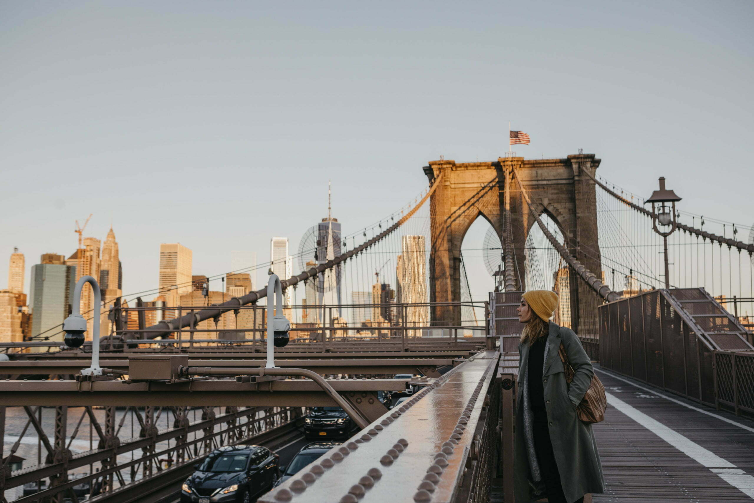 USA, New York, New York City, female tourist on Brooklyn Bridge in the morning light