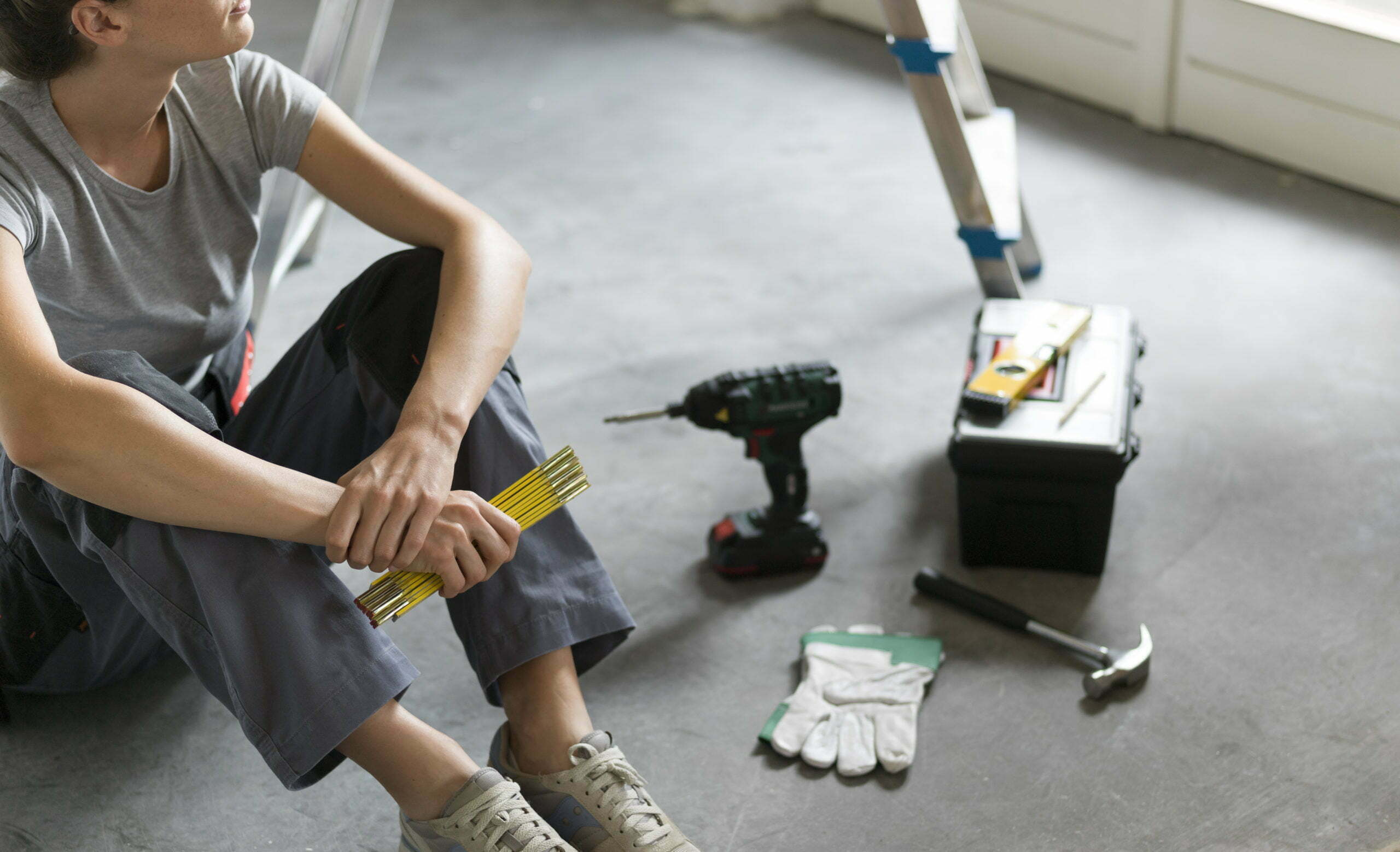 Woman sitting on the floor and planning a home renovation