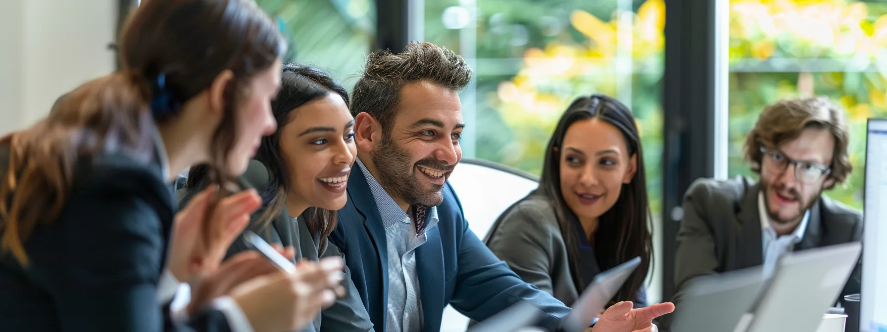 group of professionals gathered around a computer, discussing dr. gundry products and reading online community forums and reviews.